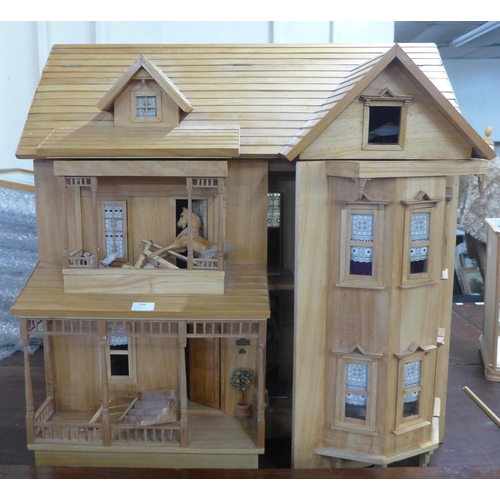 299 - A large wooden doll's house with accessories