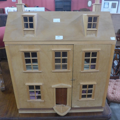 300 - A wooden doll's house, with accessories