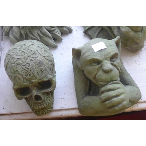 301 - Two concrete gargoyles, welcome sign, lion and a skull