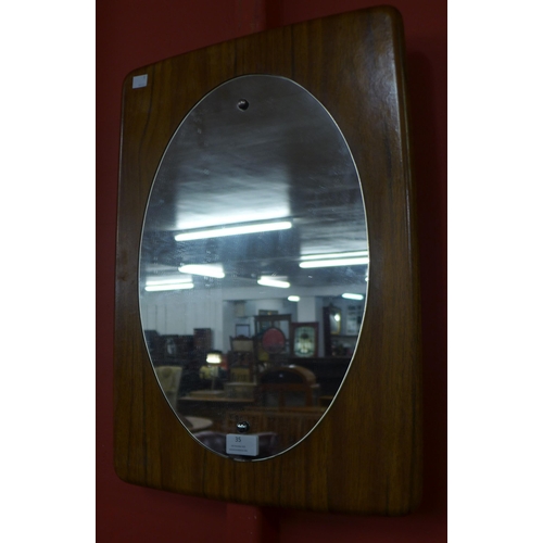 35 - A teak framed mirror and a cane armchair