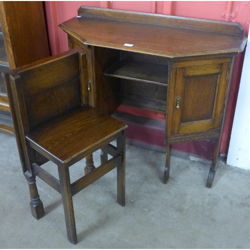 37 - A carved oak hall table/ desk with chair