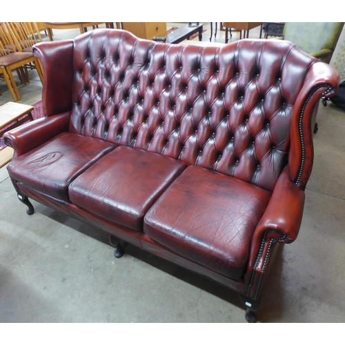 41 - A Chesterfield red leather wingback settee