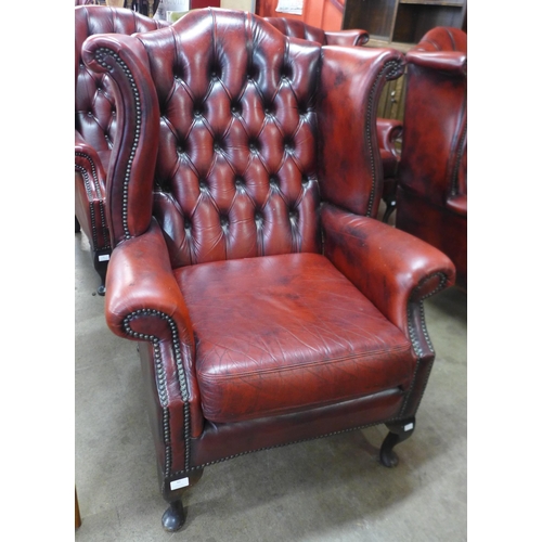 43 - A Chesterfield red leather wingback armchair