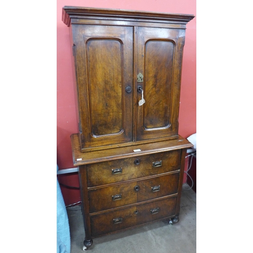 54 - A 19th Century French walnut two door cupboard on chest