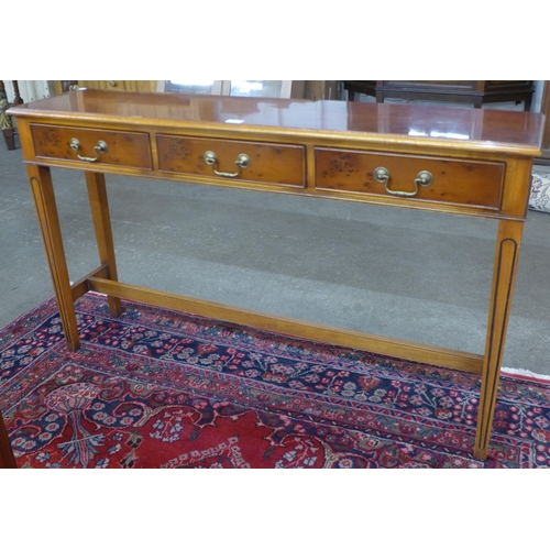 59 - A yew wood three drawer console table