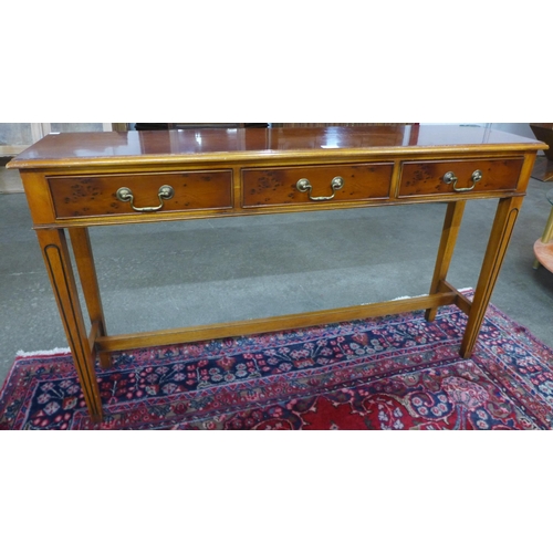 59 - A yew wood three drawer console table