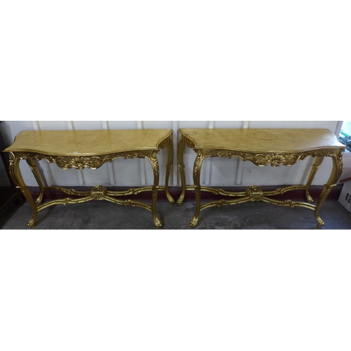 69 - A pair of Louis XV style giltwood console tables