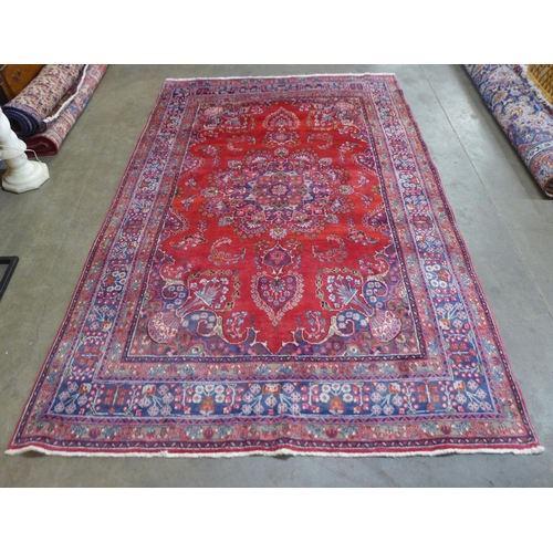 83 - An eastern red ground rug, 290 x 195cms