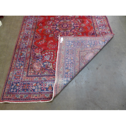 83 - An eastern red ground rug, 290 x 195cms