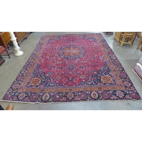 84 - An eastern red ground rug, 350 x 237cms