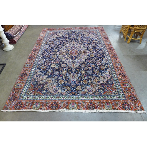 85 - An eastern blue ground rug, 314 x 225cms