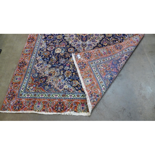 85 - An eastern blue ground rug, 314 x 225cms