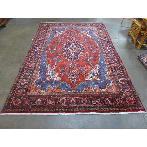 86 - An Iranian red ground rug, 305 x 20.5cms