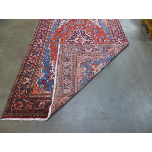 86 - An Iranian red ground rug, 305 x 20.5cms