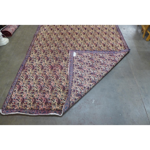 87 - An eastern beige ground rug, 323 x 223cms