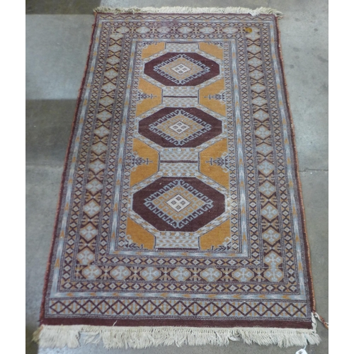 89 - An eastern brown ground rug, 158 x 93cms