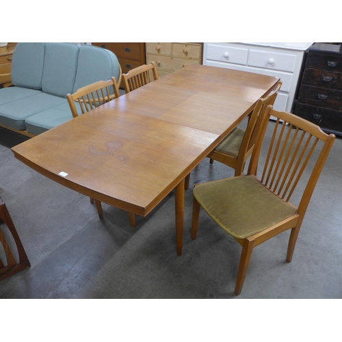 9 - A teak rectangular extending dining table and four chairs