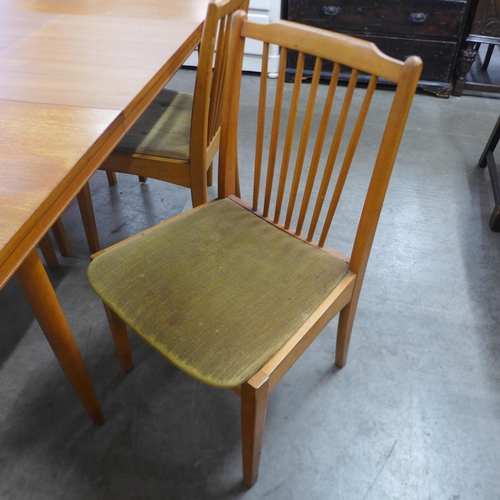 9 - A teak rectangular extending dining table and four chairs