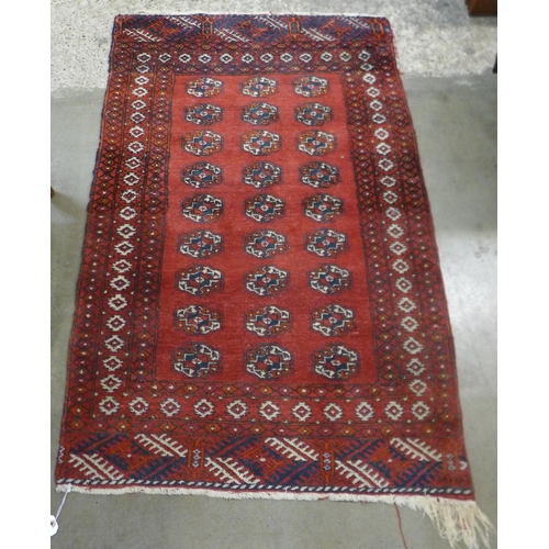 91 - An eastern red ground runner rug, 125 x 61cms