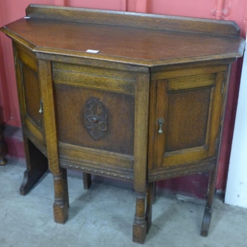 37 - A carved oak hall table/ desk with chair