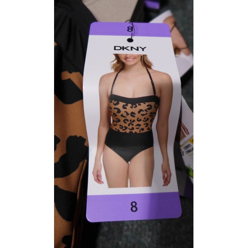 3258 - Four black and leopard print DKNY swimming costumes - size 8 * this lot is subject to VAT