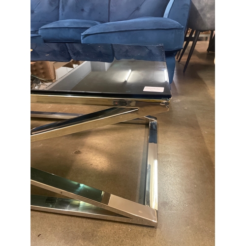 1321 - A black glass and chrome 'X' base coffee and lamp table * this lot is subject to VAT