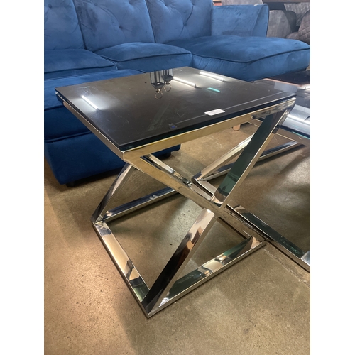 1321 - A black glass and chrome 'X' base coffee and lamp table * this lot is subject to VAT