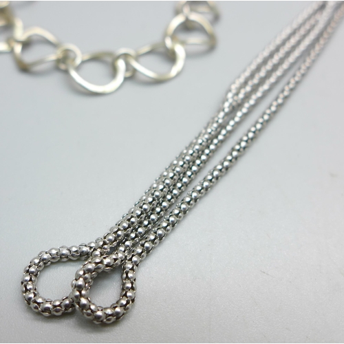 1024 - Two silver bracelets and a silver neck chain, 25g, chain 74cm