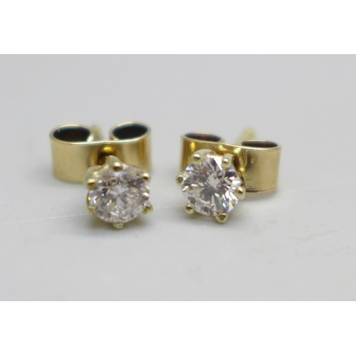 1040 - A pair of 9ct gold and diamond stud earrings