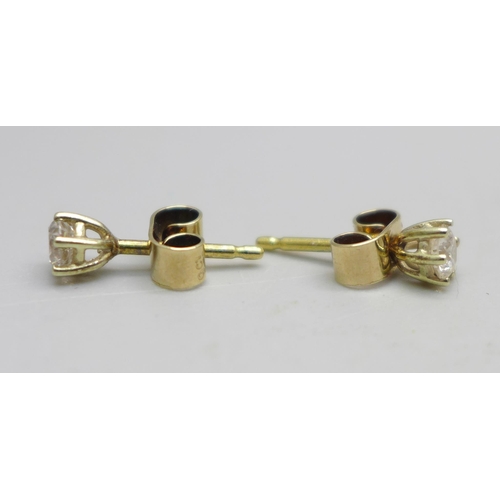 1040 - A pair of 9ct gold and diamond stud earrings