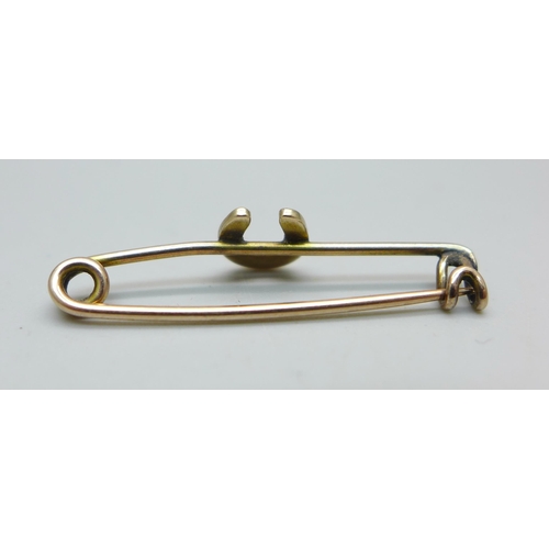 1053 - A yellow metal and seed pearl horseshoe bar brooch, tests as 9ct gold, 1.1g