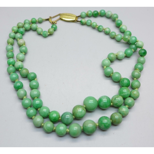 1060 - A double strand jade bead necklace, 35/36cm, fastener requires attention