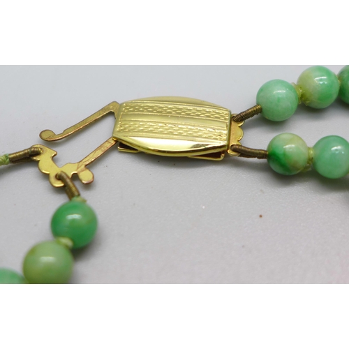 1060 - A double strand jade bead necklace, 35/36cm, fastener requires attention