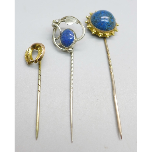 1082 - Three stick pins; one horseshoe marked gold, one Art Nouveau marked silver and one yellow metal set ... 