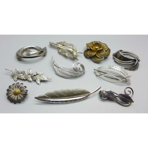 1093 - Eight silver brooches and two white metal brooches