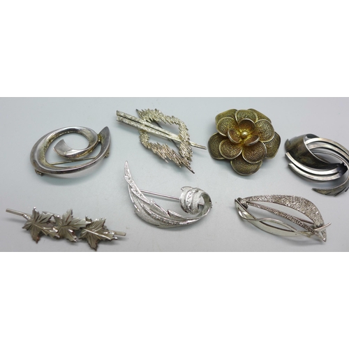 1093 - Eight silver brooches and two white metal brooches