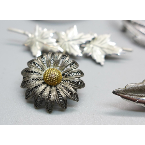 1093 - Eight silver brooches and two white metal brooches