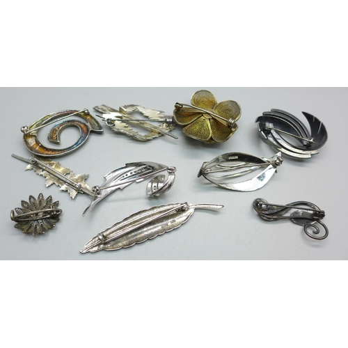 1093 - Eight silver brooches and two white metal brooches