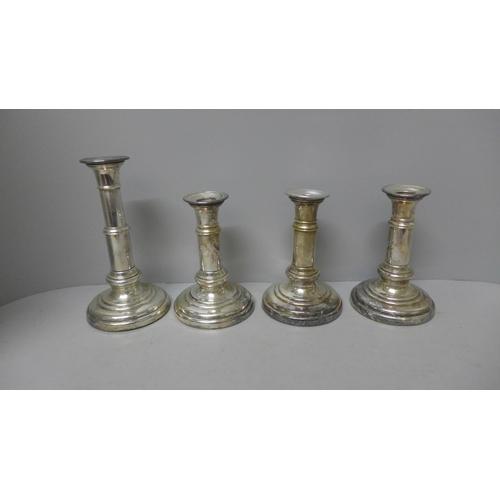 1110 - Four plated candlesticks, weighted