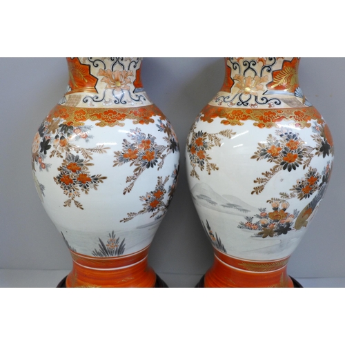 602 - A pair of Japanese Kutani vases on stands, 29.5cm