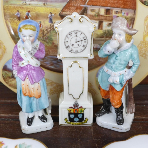 687 - Two continental figures, a crested china longcase clock, a German cabinet plate, a Spanish lidded po... 