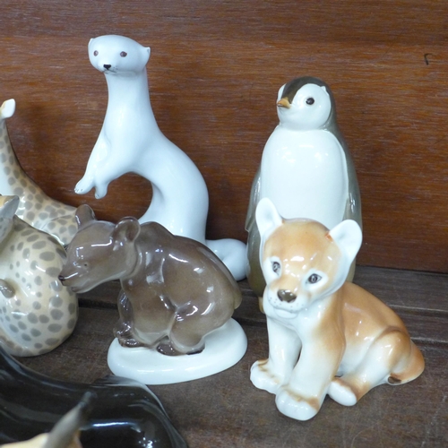 693 - A collection of USSR Lomonosov ceramic models of animals; tiger, lion cubs, giraffes, zebra, bears, ... 