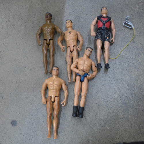 712 - A collection of twenty-one Action Man figures and villains, clothes and accessories