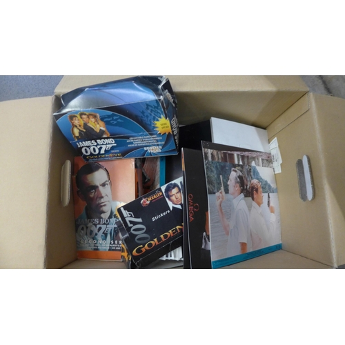 715 - A James Bond selection including lobby cards, stickers, cards, promotional material, etc.