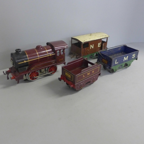 760 - A tin trunk containing O gauge model rail including a clockwork locomotive