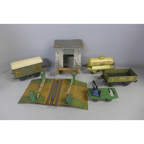 760 - A tin trunk containing O gauge model rail including a clockwork locomotive