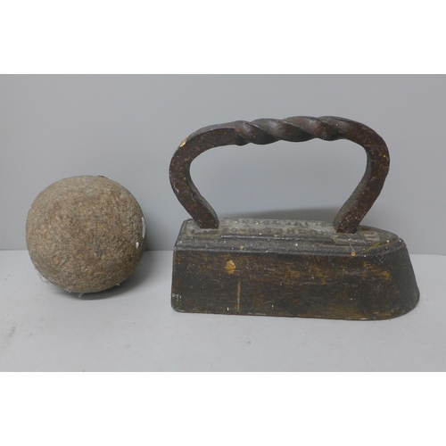 773 - A Hughes Liverpool cast iron flat iron and a cannon ball