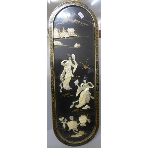 779 - A chinoiserie ebonised panel overlaid with mother of pearl, 91cm