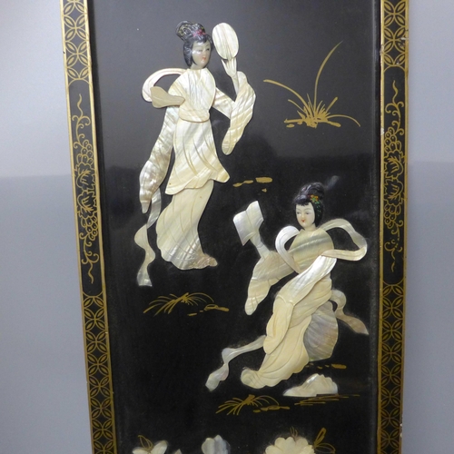 779 - A chinoiserie ebonised panel overlaid with mother of pearl, 91cm