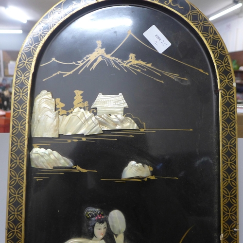 779 - A chinoiserie ebonised panel overlaid with mother of pearl, 91cm